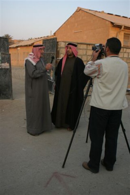 HADITHA, Iraq ? An Iraqi media crew interviews people as they finish voting at a polling site here Dec. 15. More than 15,000 people showed here to cast their vote and be a part of the history and future of Iraq.