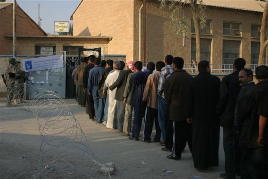 HADITHA, Iraq ? Iraqi voters line up outside the polling site before casting their vote here Dec. 15. More than 15,000 people showed here to cast their vote and be a part of the history and future of a democratic Iraq.