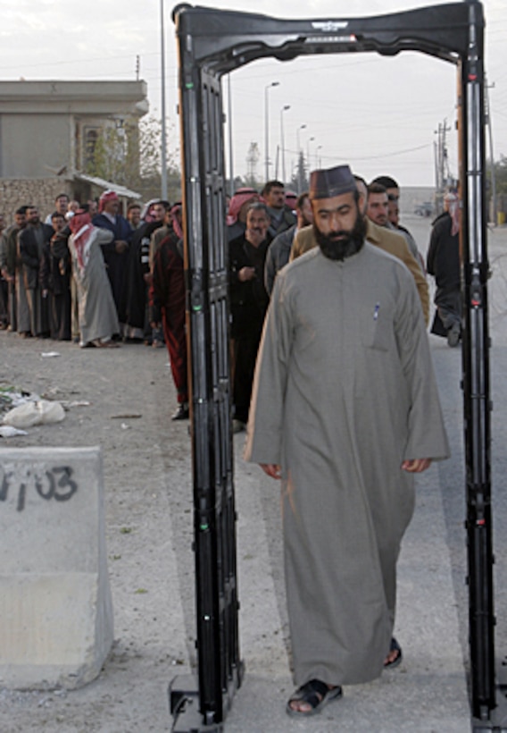 Iraqi men from Husaybah, Iraq, pass through a metal detector before entering a polling station in order to vote for a permanent Iraqi government December 15.