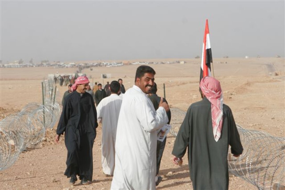 RUTBAH, Iraq ? An Iraqi man smiles as he makes his way toward a voting site here Dec. 15. In open defiance toward radical Islamist insurgents, tens of thousands of Iraqi citizens came out to the polls across the Sunni-dominated, Al Anbar province in Iraq, Dec. 15. In Rutbah, Iraqi troops provided security at polling sites with U.S. Marines from Task Force Highlander, Regimental Combat Team 2, standing by in case of any violent interference of the democratic process.