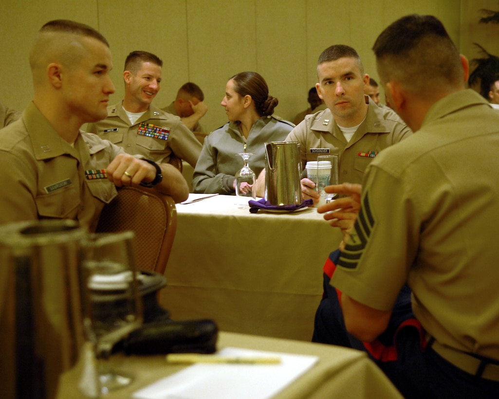 LAS VEGAS ? Master Sgt. Charles Pitts, assistant officer procurement chief, 9th Recruiting District, speaks with Capt. Kenneth Gawronski, left, and Capt. Kenneth Schoonover, center, between classes. More than 100 Marines gathered for the fiscal year 2006 Officer Selection Officer Conference, held Dec. 12 ?15, in Las Vegas.