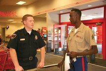 Sergeant Abdi?s?specialty is meeting people and ?handshaking,? as shown above with Chris Sergeant, a security guard at a local store.
