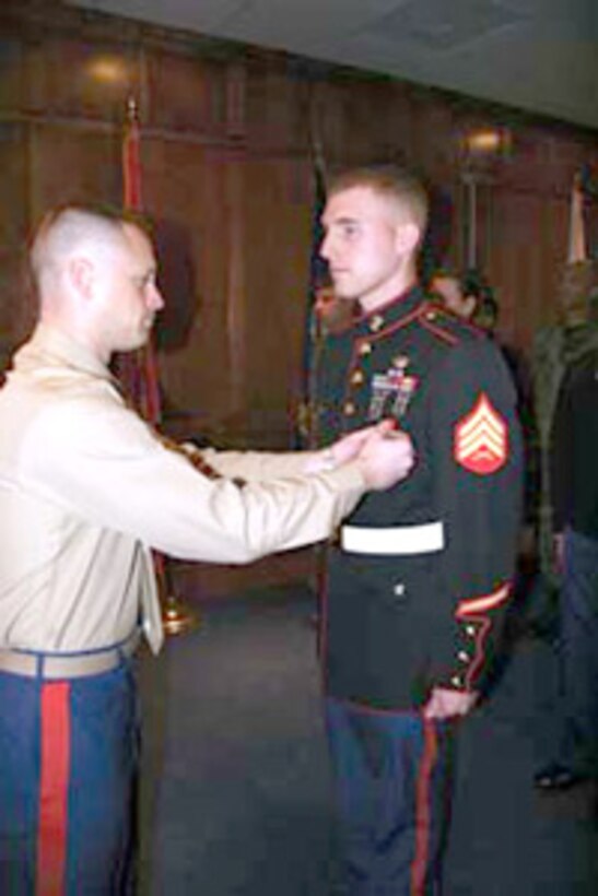 Sergeant Joshua J. Nodurft, RSS Fargo recruiter, receives the Navy and Marine Corps Medal Nov. 15, from Maj. Aaron Marx, Recruiting Station Twin Cities Commanding Officer, for life-saving actions in January 2004.