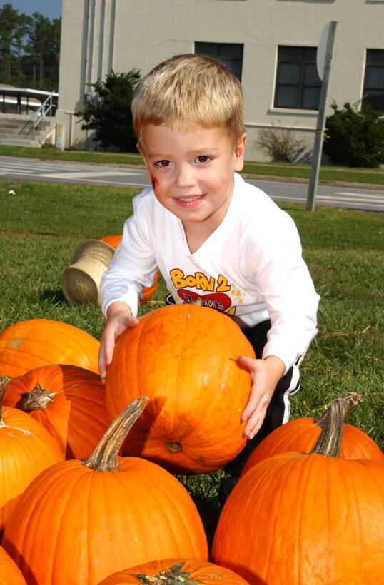 Aaron Naw, a pre-kindergarten student at Johnson Primary School, picked out a pumpkin to carve into a Halloween jack-o-lantern at the Oktoberfest Oct. 15.