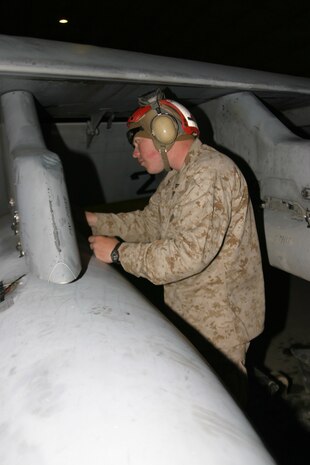 Lance Cpl. William Daniell, ordnance technician, VMFA-142 and Marietta, Ga., native works double checks a fuel tank on one of the Gator?s F/A-18A+ Hornets. The Gators have been flying since they landed here, March 7. With the help of the Marines behind the scenes, the Gators were able to fly their first combat missions 20 hours after arriving.
