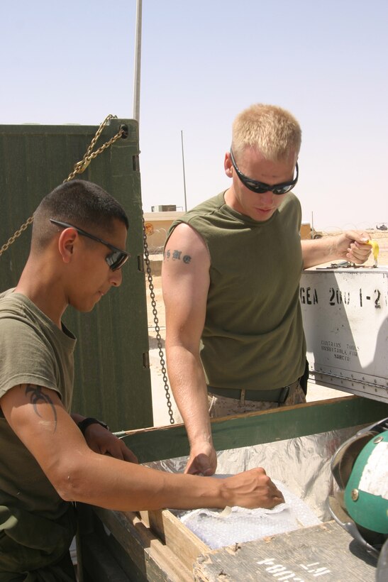 AL ASAD, Iraq - Sergeant Nicholas Lowe, logistics chief and Lance Cpl. Jerry Garza, armor with Marine Attack Squadron 311 pack up last minute things before the squadron is schedule to depart for Marine Corps Air Station Yuma, Ariz., May 17. The ?Tomcats? have been deployed to Iraq for six-months and leave with a record for the most flight hours by a Marine Harrier squadron in a combat zone.