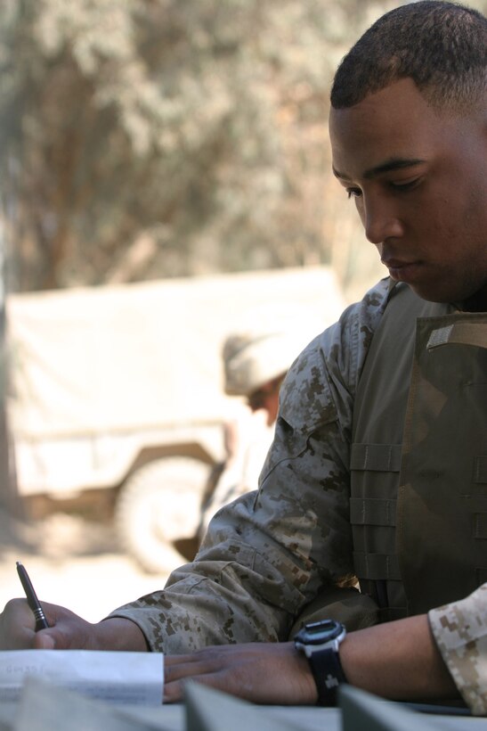 CAMP BLUE DIAMOND, AR RAMADI, Iraq -- Corporal Kelvin Brodie, a 21-year-old Raleigh, N.C. native, fills out a trip ticket before doing preventative maintenance on his High Mobility Multi-Wheeled Vehicle, March 16.  Brodie is the personal driver for 2d Marine Division, Headquarters Battalion's commanding officer.  U.S. Marine Corps photo by Sgt. Stephen D'Alessio (RELEASED)