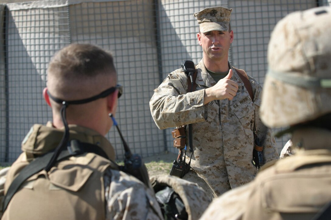 CAMP BLUE DIAMOND, AR RAMADI, Iraq -- Chief Warrant Officer 2 Michael J. Smith, guard officer and Terre Haute, Ind. native, speaks to the Marines and Sailors of the camp guard after a drill, March 16.  The random drills simulate an insurgent infiltration and the Marines react to various situations.  U.S. Marine Corps photo by Sgt. Stephen D'Alessio (RELEASED)