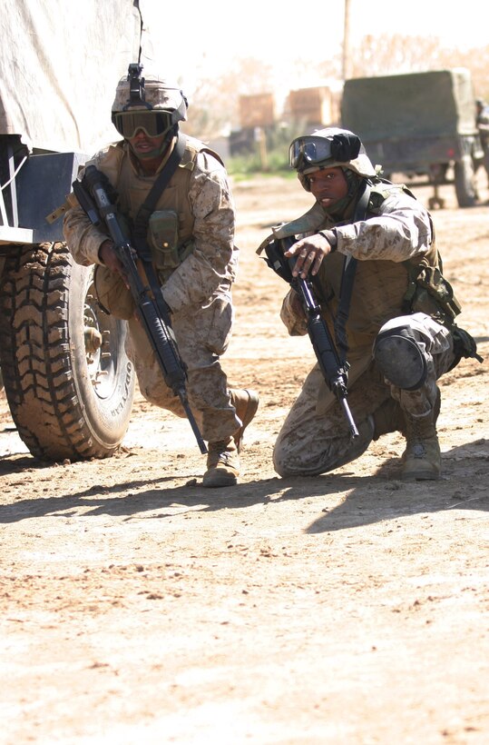 CAMP BLUE DIAMOND, AR RAMADI, Iraq -- Corporal Marquette Diggs, a 21-year-old China Grove, N.C. native and 2001 South Rowan High School graduate, guides one of his Marines on the camp's Ready React Team, March 16.  The random drills simulate an insurgent infiltration and the Marines react to various situations.  U.S. Marine Corps photo by Sgt. Stephen D'Alessio (RELEASED)