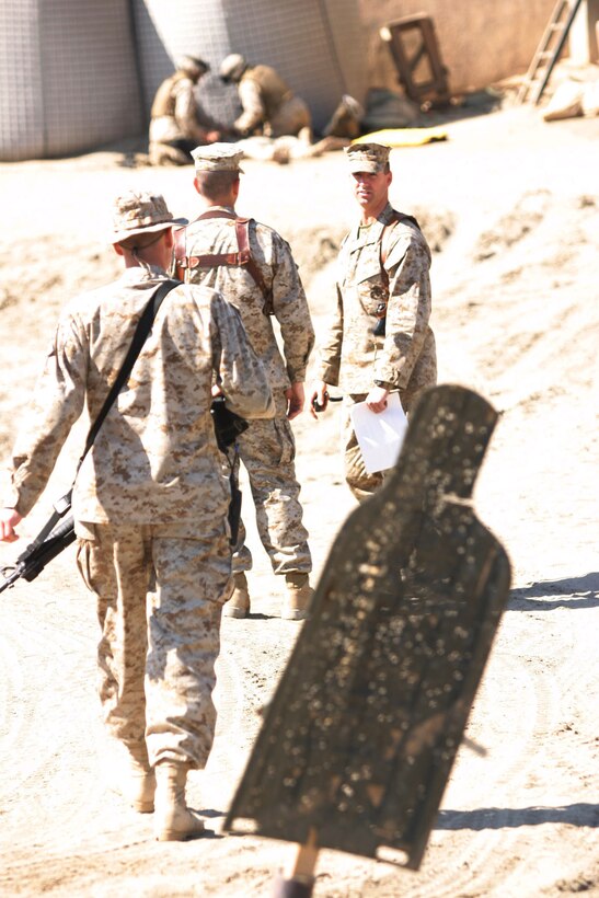 CAMP BLUE DIAMOND, AR RAMADI, Iraq -- Chief Warrant Officer 2 Michael J. Smith, guard officer and Terre Haute, Ind. native debriefs with the Marines of the camp's Ready React Team after a drill, March 16.  The random drills simulate an insurgent infiltration and the Marines react to various situations.  U.S. Marine Corps photo by Sgt. Stephen D'Alessio (RELEASED)