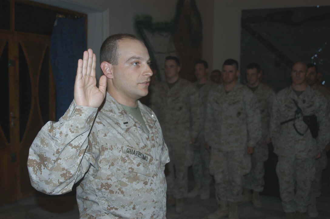 CAMP HURRICANE POINT, Ar Ramadi, Iraq (April 16, 2005) -Navy Lt. j.g Mike A. Quaresimo, information operations officer, Information Operation, Headquarters and Service Company, 1st Battalion, 5th Marine Regiment, holds up his right hand and takes his oath of office during a promotion ceremony here. The 32-year-old from Poughkeepsie, N.Y., was promoted to the rank of Navy lieutenant in front of more than 30 service members with the infantry battalion who attended to honor him on his day of advancement. Quaresimo volunteered to accompany warriors with 1st Battalion, 5th Marines on their deployment to Ar Ramadi in support of Operation Iraqi Freedom. Photo by Cpl. Tom Sloan