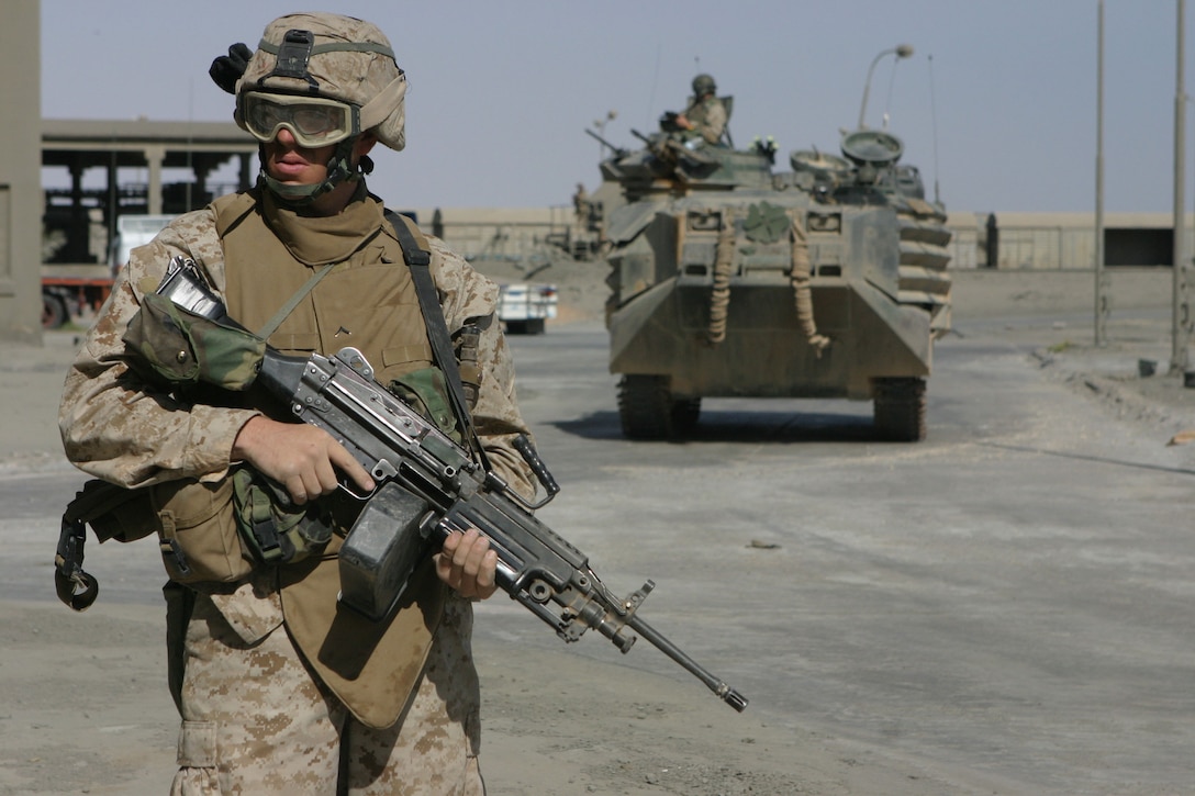 AL QA'IM, Iraq (April 16, 2005)- Pfc. Brian D. Murphy, 21, a squad automatic weapon gunner with 2nd Platoon, Company K, 3rd Battalion, 2nd Marine Regiment, Regimental Combat Team-2 provides security outside the concrete plant during a cordon and knock here. The Boston, Mass., native and his platoon were searching for any type of material that could be used to oppose U.S. Forces. Murphy is a 2002 Norwell High School graduate. Official U.S. Marine Corps photo by Lance Cpl. Lucian Friel (RELEASED)