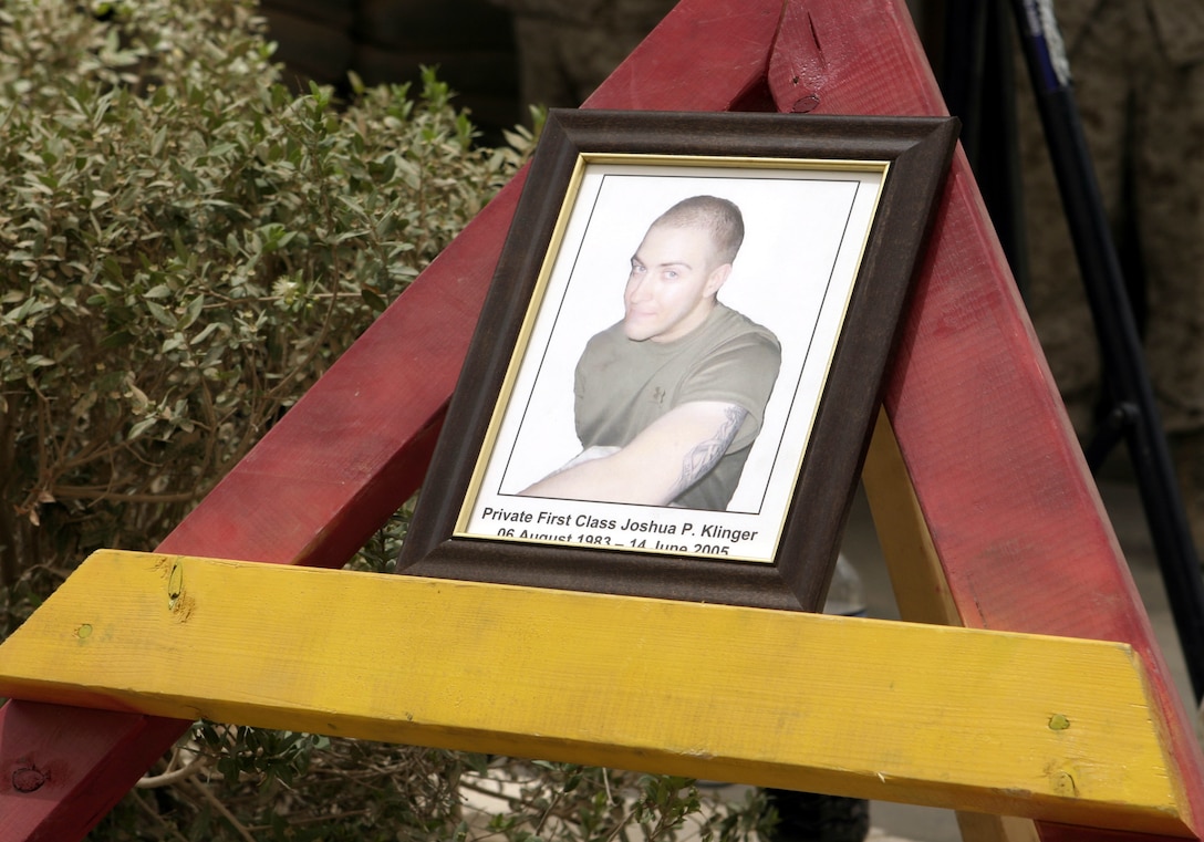 FALLUJAH, Iraq - Pfc. Joshua Klinger's photograph rests atop a stand inside Company B, 1st Battalion, 6th Marine Regiment's base of operations here June 16 during his memorial service.  The 21-year-old North Hampton, Penn. native passed away June 14 when an improvised explosive device detonated near his position while patrolling Fallujah's streets.