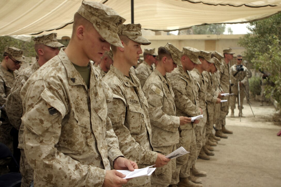 FALLUJAH, Iraq - Marines with Company B, 1st Battalion, 6th Marine Regiment sing a hymn in remembrance of fellow Marine, Pfc. Joshua Klinger, during a memorial service here June 16.  Klinger passed away June 14 when an improvised explosive device detonated near his position while patrolling Fallujah's streets.
