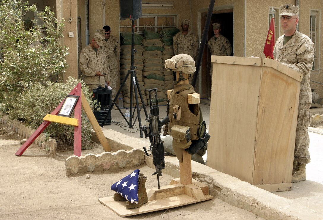 FALLUJAH, Iraq - Navy Lt. Richard Ryan, 1st Battalion, 6th Marine Regiment's chaplain, delivers inspirational words during Pfc. Joshua Klinger's memorial service here June 16.  Klinger passed away June 14 when an improvised explosive device detonated near his position while patrolling Fallujah's streets.