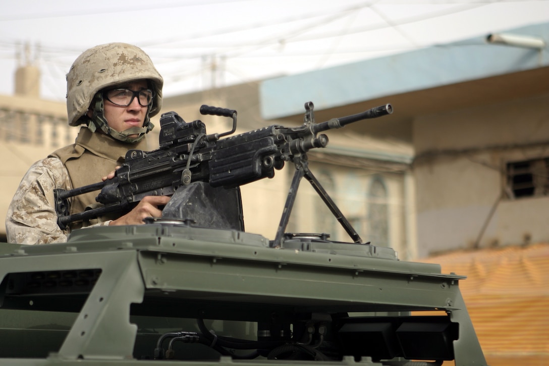 FALLUJAH, Iraq - Lance Cpl. Josh Griffin, an infantryman with Surveillance, Target and Acquisition Platoon, Company W, 1st Battalion, 6th Marine Regiment, provides security from atop his new MAK HMMWV (Marine Armor Kit equipped High Mobility Multi-Wheeled Vehicle) in a street in downtown Fallujah.  The 21-year-old Grenada, Miss. native's unit is currently receiving several of these hardened vehicles to protect the troops against roadside bomb detonation and small arms fire.