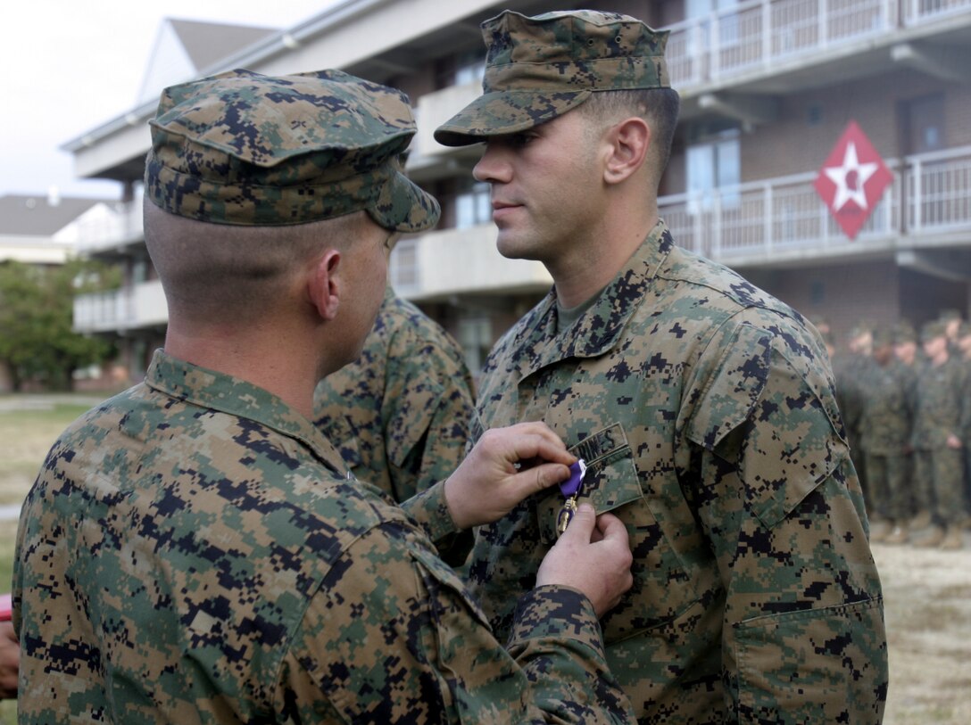 MARINE CORPS BASE CAMP LEJEUNE, N.C. - Lance Cpl. Josh Barrett, an infantryman with Surveillance, Target and Acquisition Platoon, Weapons Company, 1st Battalion, 6th Marine Regiment, is presented his Purple Heart Medal here Nov 16.  The 25-year-old Memphis, Tenn. native was awarded this medal for injuries sustained after a roadside bomb detonated near his vehicle while he and his teammates had been conducting security and stability operations outside Fallujah, Iraq this summer.