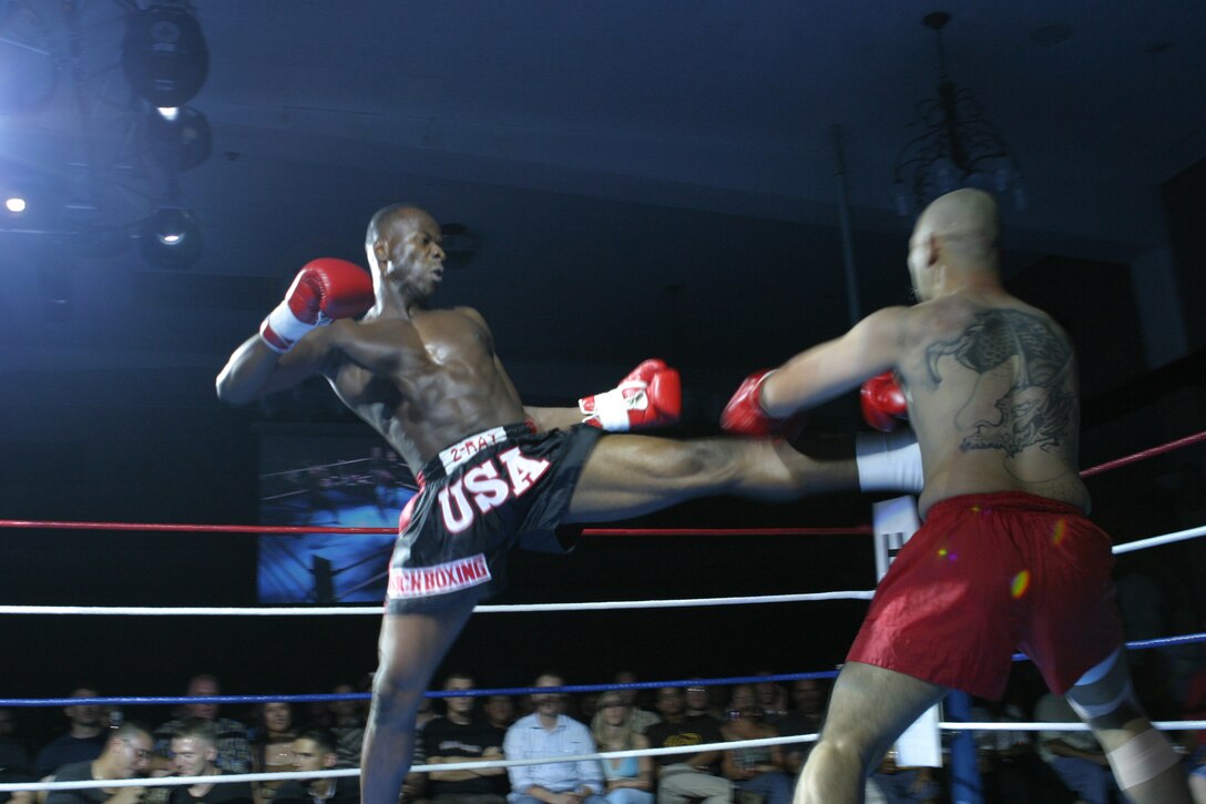 050716-M-1837P-001 KADENA AIR BASE, OKINAWA, Japan - Sgt. Idris N. Turay lands a massive kick to the midsection of Shota Koja during a kickboxing match in the King of Fights X at the Rocker NCO Club here July 16. Turay went on to win the fight by way of knock out in the second round. This Cedar Falls, Iowa, Native is an operations noncommissioned officer with Headquarters Group, III Marine Expeditionary Force. (Official U.S. Marine Corps photo by Pfc. C. Warren Peace)(Released)