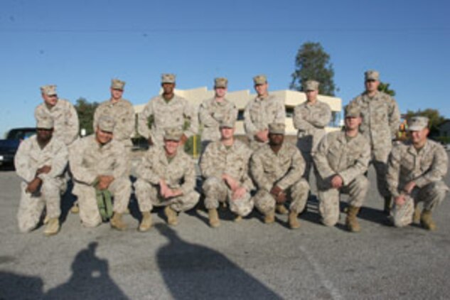 Marines with 2nd Battalion, 7th Marine Regiment?s Remain Behind Element pause for a moment after their morning formation of in front of the 7th Marines Regimental command post Nov. 16.  The ?War Dogs? who remained behind could not deploy due to medical issues, legal issues or are approaching their end-of-active-duty date.  Some Marines returned early from their deployment from being wounded.