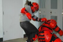 INDIAN HEAD, Md-Cpl. Tashna Hicks-Wert, a Marine who serves with the Chemical Biological Incident Response Force (CBIRF) delivers a knee strike to the kidneys of a would-be attacker during the Rape Aggression Defense (RAD)course at the unit Nov. 16.  The three-week course builds upon the instinct of self-preservation and incorporates basic martial arts principles that uphold its key theme of breaking contact with the aggressor and escaping to safety.