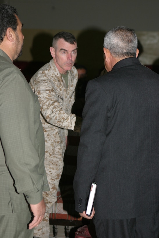 The 2d Marine Division's Assistant Division Commander, Brig. Gen. Joseph J. McMenamin greets members of the Al Anbar Provincial Council at the Provincial Capital Building here during the councils first meeting. The officials elected to represent the Al Anbar Province invited McMenamin to attend their first meeting so that he could see the progress being made in the province.