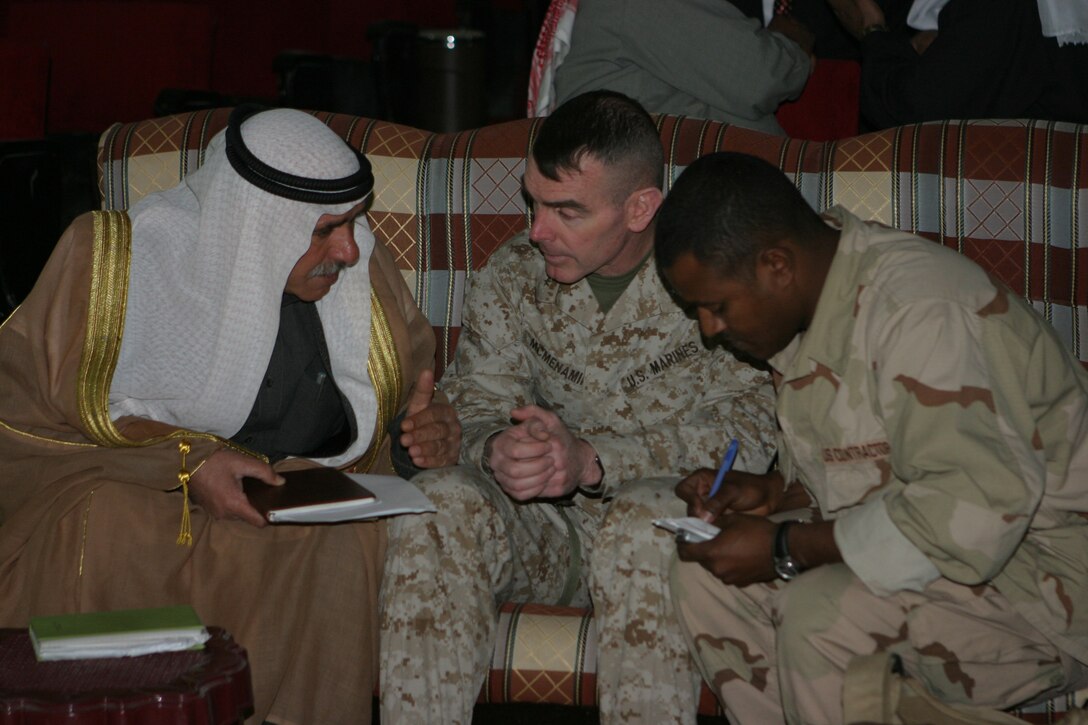 The 2d Marine Division's Assistant Division Commander, Brig. Gen. Joseph J. McMenamin talks with a member of the Al Anbar Provincial Council with the assistance of a translator at the Provincial Capital Building here during the councils first meeting. The officials elected to represent the Al Anbar Province invited McMenamin to attend their first meeting so that he could see the progress being made in the province.