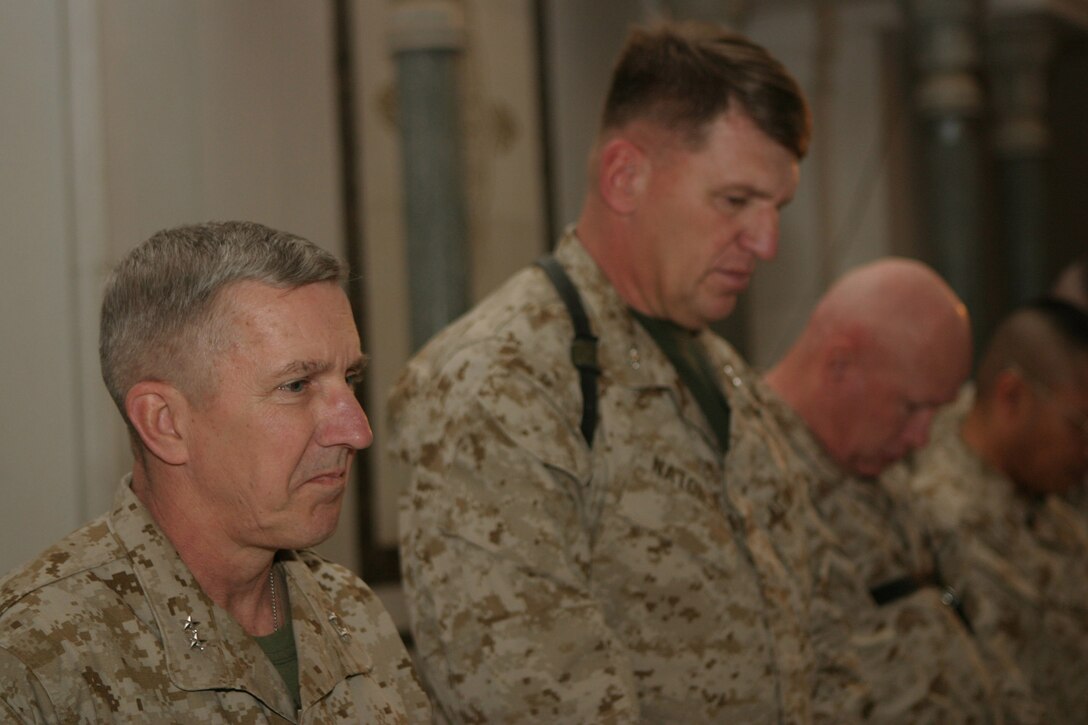Major Gen. Richard A. Huck, 2d Marine Division commanding general, takes solace in prayer as the chaplain gives the invocation for the Transfer of Authority ceremony with Maj. Gen. Richard F. Natonski, 1st Marine Division commanding general, March 17.  Natonski relinquished authority of operations in the Al Anbar Province to Huck during the ceremony.  U.S. Marine Corps photo by Sgt. Stephen D'Alessio (RELEASED)