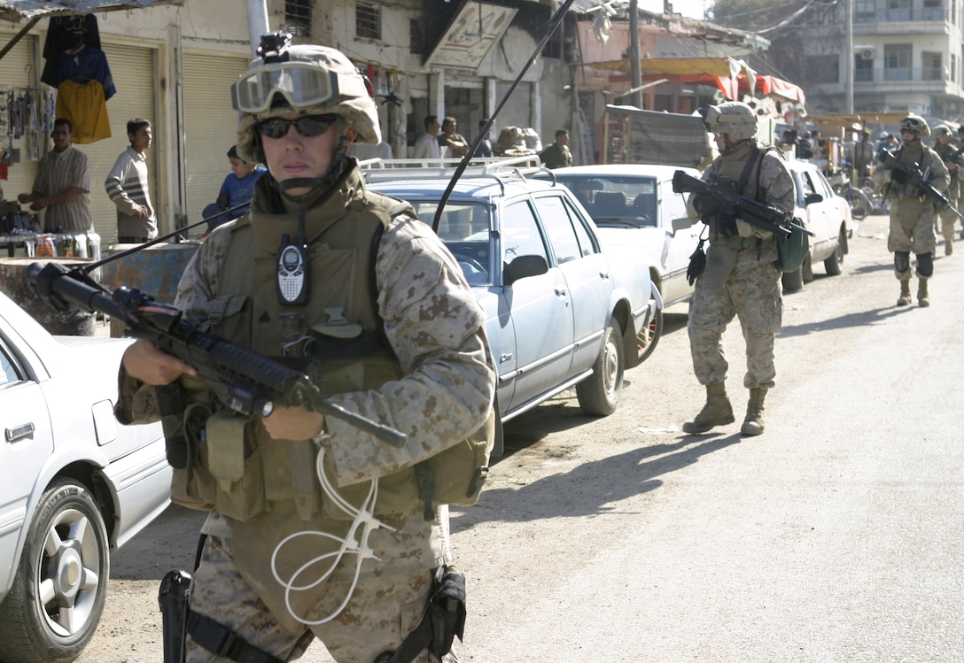 FALLUJAH, Iraq - A Marine with Company C, 1st Battalion, 6th Marine Regiment patrols the streets near the Farwat bakery here April 17.  Iraqi Security Forces and Company C personnel conducted a raid on the bakery, detained nine suspected insurgent supporters, and confiscated a pistol and numerous forms of anti-Coalition forces propaganda.