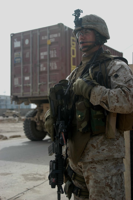 AR RAMADI, Iraq (May 17, 2005) - As a truck carrying a sea container full of medical supplies heads towards the entrance of the Maternity and Children's Hospital here, Capt. John W. Maloney, commander of Company C, 1st Battalion, 5th Marine Regiment, communicates with his fellow Marines on his radio. The 36-year-old from Chicopee, Mass., joined other Marines with the infantry battalion and soldiers from the Army's 2nd Brigade Combat Team and conducted an operation to improve medical care for residents of the city and foster good will toward coalition forces. The Marines and soldiers delivered four sea containers of medical supplies - valued at more than $500,000 - to the hospital. The supplies ranged from heart monitors and antibiotics to new bed sheets and bandages. Photo by: Cpl. Tom Sloan