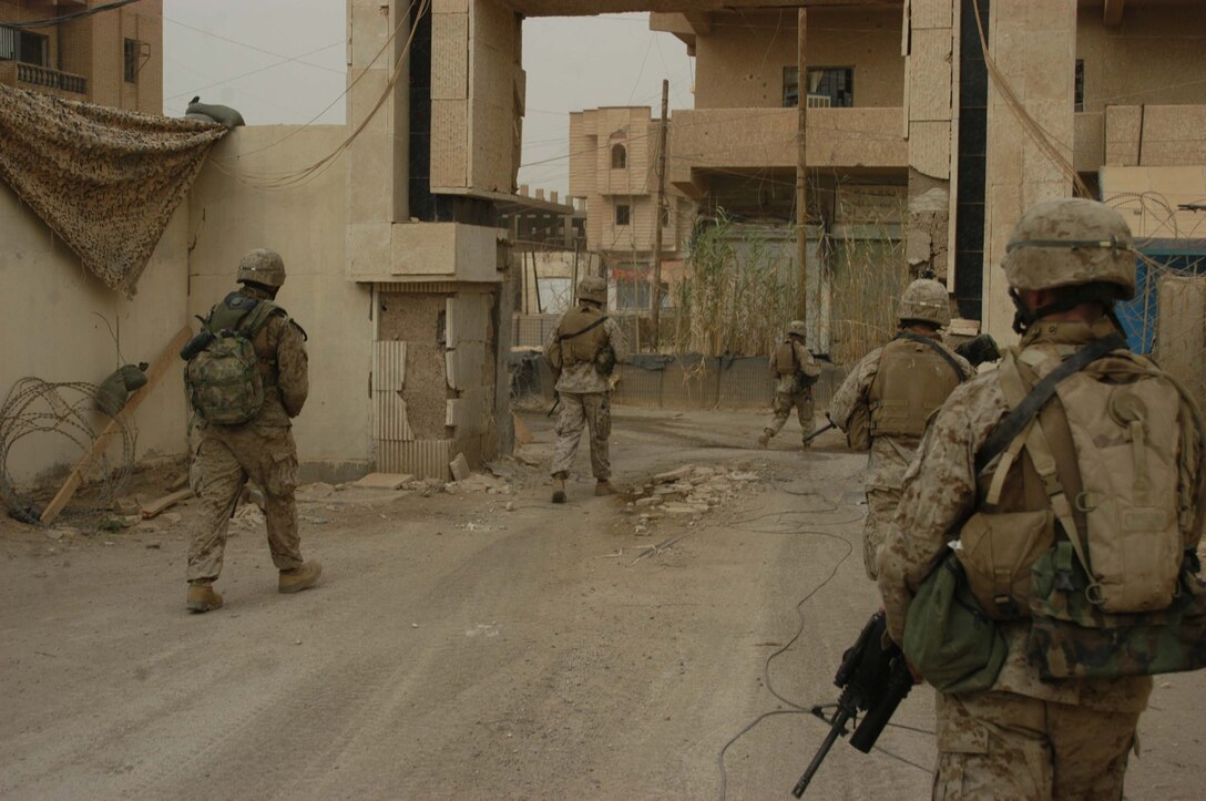 AR RAMADI Iraq (June 17, 2005) - Marines with 2nd Squad, 2nd Platoon, Company A, 1st Battalion, 5th Marine Regiment, leave the confines of an observation post and enter the street during a search mission in the city here. Marines with Company A's 2nd and 3rd Platoons were conducting a search mission when they were called on to provide security for a platoon of Company C Marines who hit an IED. The Marines set up lookouts on rooftops a few hundred yards from the attack seen. They remained in their surveillance positions for more than two hours. Photo by: Cpl. Tom Sloan