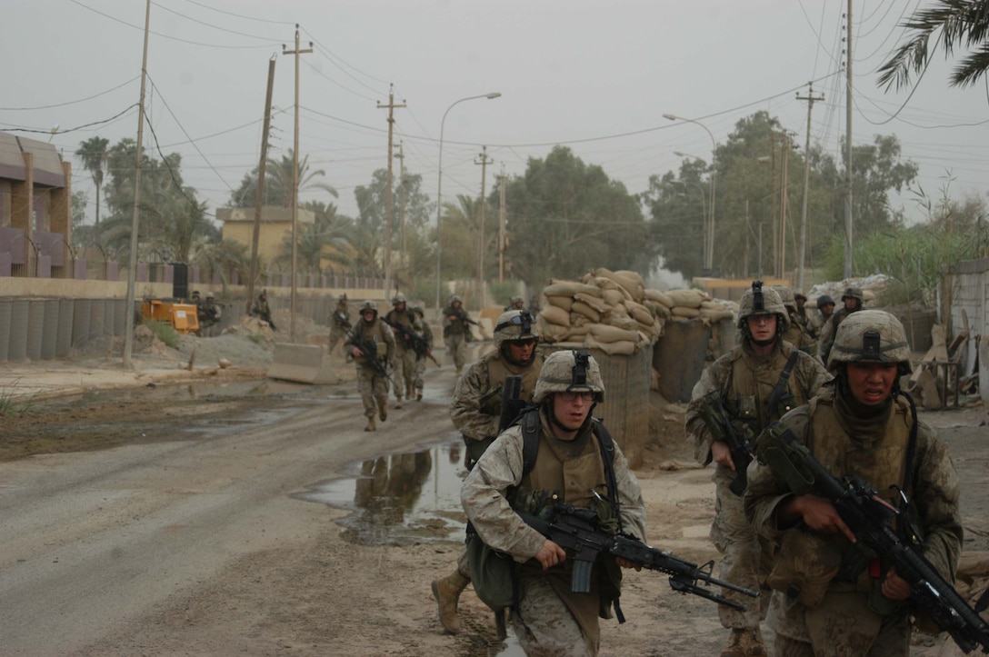 050616-M-0245S-012 AR RAMADI Iraq (June 17, 2005) - Marines with 2nd Squad, 2nd Platoon, Company A, 1st Battalion, 5th Marine Regiment, quickly move down a street during a search mission in the city here. Marines with Company A's 2nd and 3rd Platoons were conducting a search mission when they were called on to provide security for a platoon of Company C Marines who hit an IED. The Marines set up lookouts on rooftops a few hundred yards from the attack seen. They remained in their surveillance positions for more than two hours. Photo by: Cpl. Tom Sloan