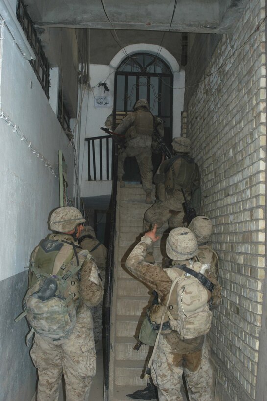 AR RAMADI Iraq (June 17, 2005) - Marines with 2nd Squad, 2nd Platoon, Company A, 1st Battalion, 5th Marine Regiment, prepare to enter a room in a building during a search mission in the city here. Marines with Company A's 2nd and 3rd Platoons were conducting a search mission when they were called on to provide security for a platoon of Company C Marines who hit an IED. The Marines set up lookouts on rooftops a few hundred yards from the attack seen. They remained in their surveillance positions for more than two hours. Photo by: Cpl. Tom Sloan