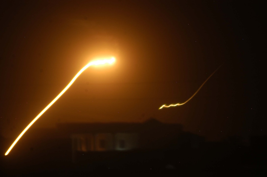 AR RAMADI Iraq (June 17, 2005) - An enemy rocket cuts through the night's sky here while Marines with 1st Battalion, 5th Marine Regiment battle insurgents. Marines with Company A's 2nd and 3rd Platoons were conducting a search mission when they were called on to provide security for a platoon of Company C Marines who hit an IED. The Marines set up lookouts on rooftops a few hundred yards from the attack seen. They remained in their surveillance positions for more than two hours. Photo by: Cpl. Tom Sloan