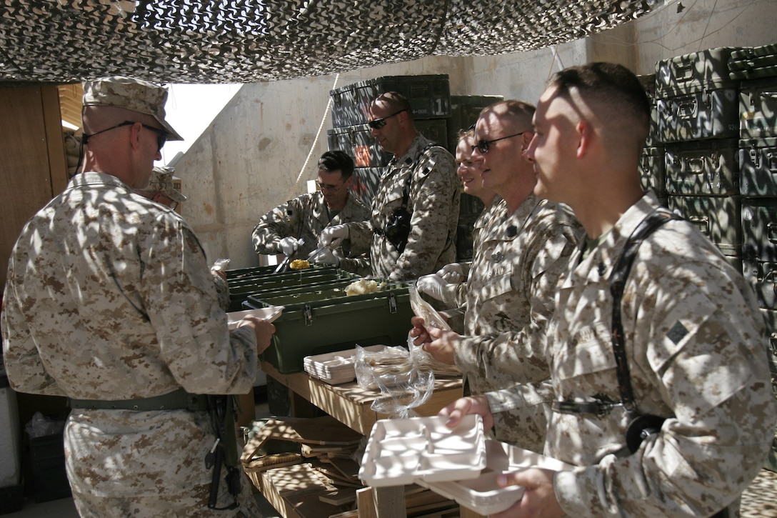 Camp Hadithah Dam, Hadithah, Al Anbar (June 17, 2005) -- The senior hospital corpsmen serve t-bone steaks, mashed potatoes, and corn to their fellow docs in celebration of the 107th birthday of the U.S. Navy Hospital Corps.  The men washed down their gourmet dinners with "near beer", and had chocolate ice cream and cake for dessert.  For corpsmen, the celebration is equivalent to the Marine Corps birthday ball celebrated on November 10.