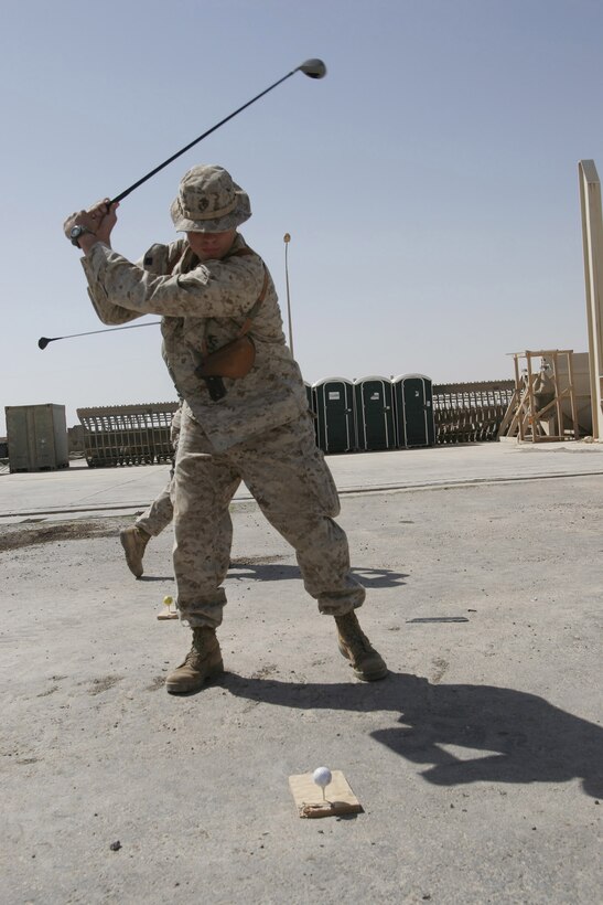 Camp Hadithah Dam, Hadithah, Al Anbar (June 17,2005) -- Hospital Corpsman 2nd Class G. Taylor Cleveland perfects his drive on the top deck of Hadithah Dam.  Family and friends send the the Navy docs boxes of golf balls for their driving practice.  Unfortunately they have a one-hit lifespan, disappearing either into the lake or into the desert.