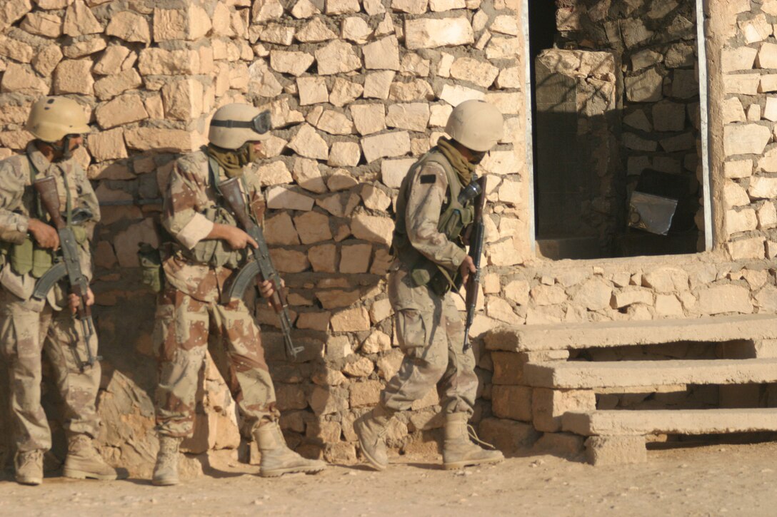 KARABILAH, Iraq- (June 17, 2005)  Members of the Iraqi Security Force clear a house and search the family that occupies it.  Operation Spear is conducted to destroy insurgency leadership strong points. (Official USMC photo by Cpl Neill A. Sevelius)(RELEASED)