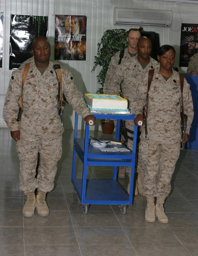 Four Sailors escort the birthday cake for the Navy's Hospital Corps 107th birthday  during a ceremony held here June 17 to honor the most decorated job field in naval history.
