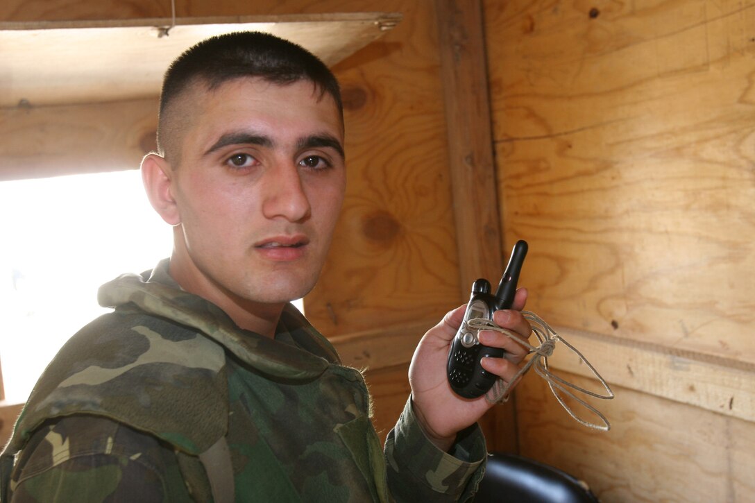 Hadithah Dam, Hadithah, Iraq.-- An Azerbaijani soldier uses an Inter-Squad Radio to communicate with a lookout post.  The Azerbaijanis received most of their communication equipment from the United States.  Besides the company in Iraq, Azerbaijan also has troops in Kosovo and Afghanistan.  (Photo by Lance Cpl. Marc Fencil)