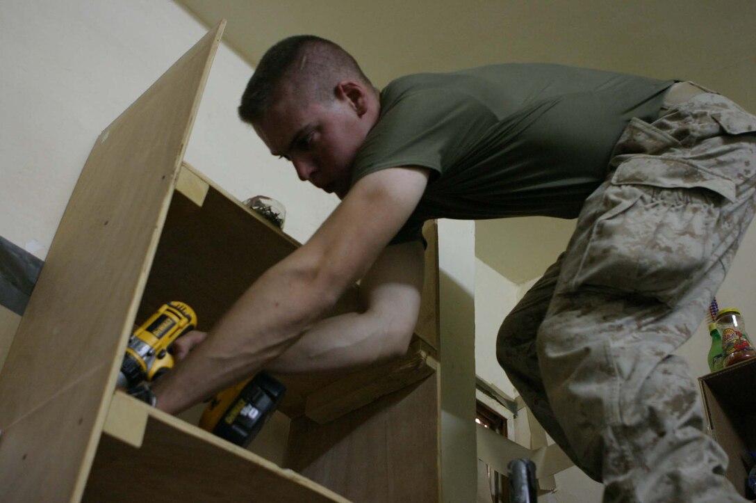 LCpl. Shane P. Costello, provisional infantryman, 2nd squad, 2nd platoon, Kilo Battery, 3rd Battalion, 10th Marines, 2d Light Armored Reconnaissance Battalion, Regimental Combat Team-2, works on the border of Iraq and Syria to help maintain the security of the country.  While not providing securtiy or working at the main gate Costello works to improve the Foward Operating Base.  (Photo by LCpl. Zachary W. Lester)