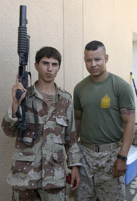 FALLUJAH, Iraq - Sgt. Jose Martins, chief instructor for 1st Battalion, 6th Marine Regiment's Iraqi Security Forces training cadre, poses for a photo alongside an Iraqi soldier during a combat leaders course here.  The 26-year-old Queens Village, N.Y. native and his seven teammates school dozens of Iraqi soldiers and policemen every month on topics such as first aid in combat, urban war fighting tactics, and weapons handling skills.