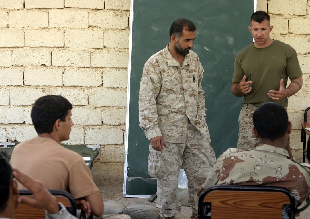 FALLUJAH, Iraq - Cpl. Brandon Connelly, an instructor with 1st Battalion, 6th Marine Regiment's Iraqi Security Forces training cadre, lectures a class of soldiers and policemen here August 1.  The 28-year-old Toms River, N.J. native and his seven teammates school dozens of Iraqi soldiers and policemen every month on topics such as first aid in combat, urban war fighting tactics, and weapons handling skills.