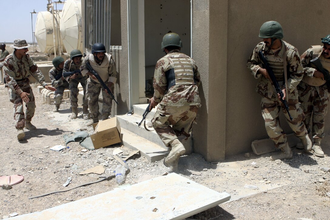 FALLUJAH, Iraq - Iraqi soldiers practice assaulting a building during a training evolution 1st Battalion, 6th Marine Regiment's Iraqi Security Forces training cadre personnel supervised here August 2.  Since mid-March, battalion personnel have trained approximately 600 Iraqi personnel on topics such as first aid in combat, infantry tactics, and convoy driving skills.  Iraqi forces are fully integrated into every operation the battalion's Marines and sailors conduct in and around the city.