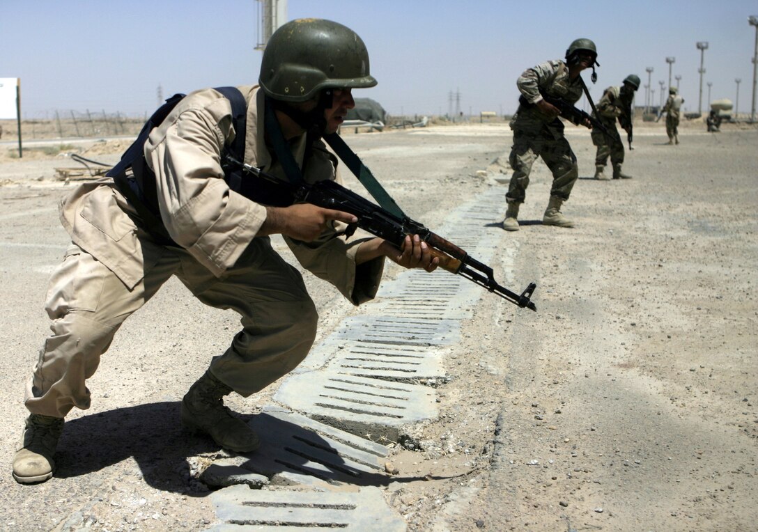 FALLUJAH, Iraq - Iraqi soldiers practice rushing toward a hostile stronghold during a training evolution 1st Battalion, 6th Marine Regiment's Iraqi Security Forces training cadre personnel supervised here August 2.  Since mid-March, battalion personnel have trained approximately 600 Iraqi personnel on topics such as first aid in combat, infantry tactics, and convoy driving skills.  Iraqi forces are fully integrated into every operation the battalion's Marines and sailors conduct in and around the city.