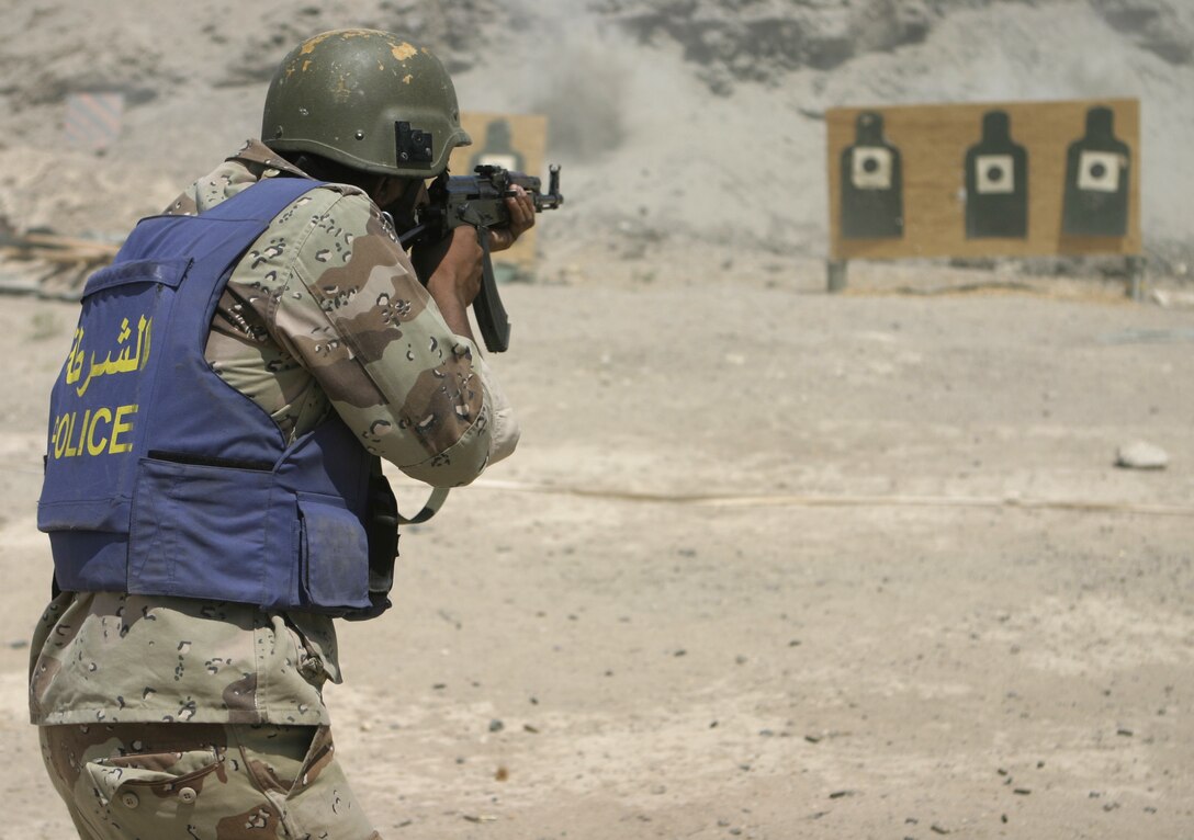 FALLUJAH, Iraq - An Iraqi policeman fires his AK-47 assault rifle during a training range 1st Battalion, 6th Marine Regiment's Iraqi Security Forces training cadre supervised here Aug. 3.  Since mid-March, 1st Battalion, 6th Marine Regiment personnel have trained approximately 600 Iraqi personnel on topics such as first aid in combat, infantry tactics, and convoy driving skills.  Iraqi forces are fully integrated into every operation the battalion's Marines and sailors conduct in and around the city.