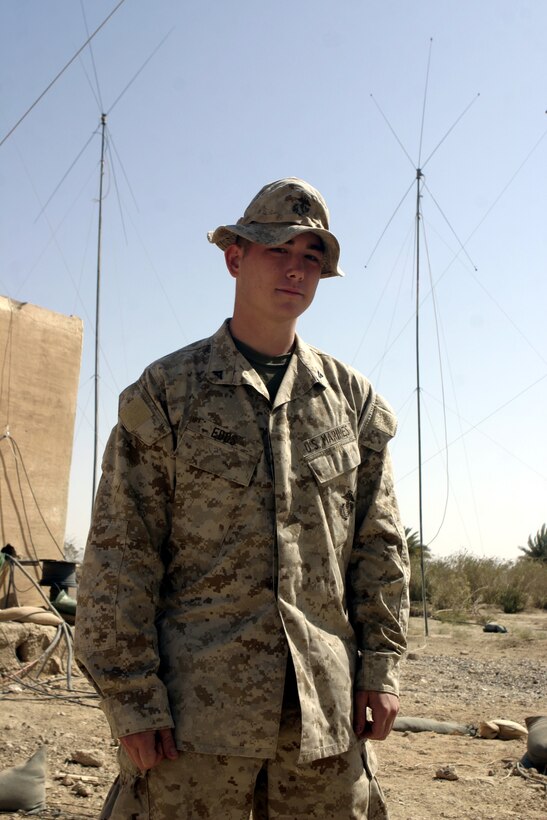 CAMP BAHARIA, Iraq - Lance Cpl. Jason V. Edds, a radio operator with 1st Battalion, 6th Marine Regiment, mans his unit's communications array, or 'ant farm,' here Aug. 17.  The 20-year-old Oklahoma City native works alongside fellow communications Marines to keep their headquarters connected with each of their subordinate units in Fallujah by regularly cleaning, fixing and fine-tuning their antennas and radios.