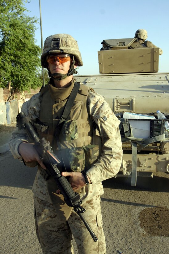 FALLUJAH, Iraq - Corporal Mychal McVicker, an infantryman with 2nd Combined Anti-Armor Team, Weapons Company, 1st Battalion, 6th Marine Regiment, provides security outside his vehicle while other battalion infantrymen patrol the city streets Sept. 17.  The 22-year-old Elizabeth City, N.C. native and his teammates have been providing outer perimeter security during hundreds of patrols, raids and house-to-house search missions since arriving here in mid-March.