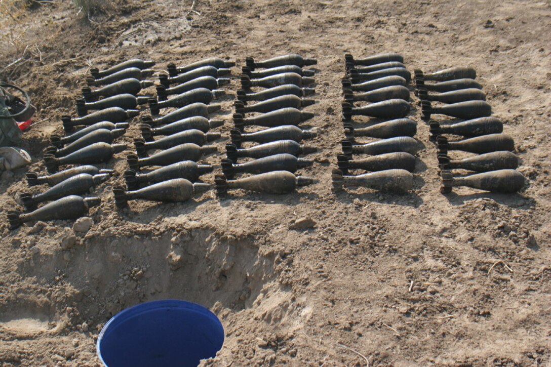 051117-M-2607O-002 - A large number of 82 millimeter mortars were discovered in blue plastic buckets buried in the ground along a canal during Operation TRIFECTA on Nov 17.