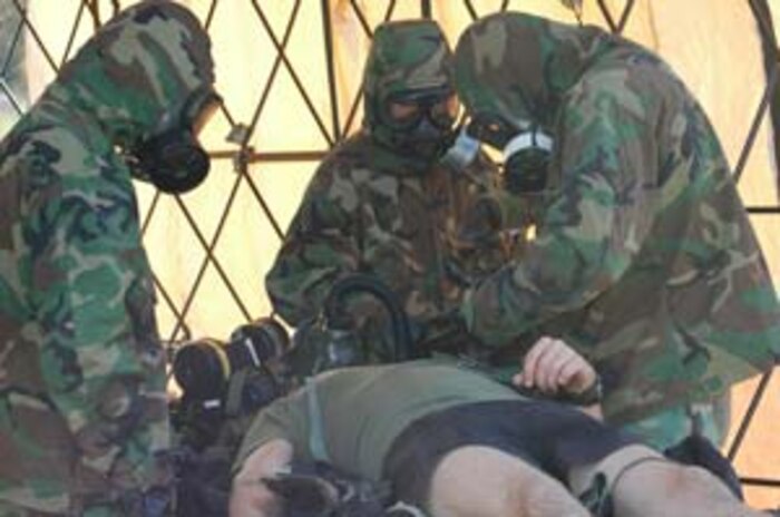 INDIAN HEAD,Md.-Chemical Biological Incident Response Force (CBIRF) Marines take care of one of their own during a simulated high-yield explosive event at the Raymond M. Downey Sr. Training Facility Nov. 17.  In addition to responding to the threat of chemical contamination, the Marines and Sailors are challenged to take into account the possibility of the threat of improvised explosive devices (IED's) employed in their area of responsibility.