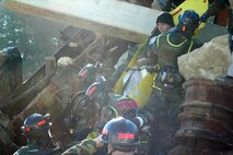 INDIAN HEAD, Md.-Marines from the Chemical Biological Incident Response Force (CBIRF) rescue a survivor from a catastrophic collapse during a simulated high-yield explosive event at the Raymond M. Downey Sr. Training Facility Nov. 17.  The primary challenge during this evolution was finding the manpower to execute the mission said Cpl. Shane Czesak, a crash fire rescue technician and evaluator for the training.  "The rescue element overcame the challenge of insufficient manpower by augmenting their team with personnel from other sections of the Initial Response Force (IRF) with tasks such as debris removal and patient extract," said Czesak.  CBIRF's 38 man rescue platoon conducts missions similar to urban search and rescue teams yet can also respond when there is a threat of chemical contamination.