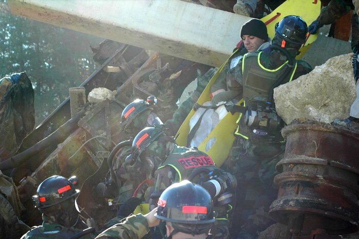 INDIAN HEAD, Md.-Marines from the Chemical Biological Incident Response Force (CBIRF) rescue a survivor from a catastrophic collapse during a simulated high-yield explosive event at the Raymond M. Downey Sr. Training Facility Nov. 17.  The primary challenge during this evolution was finding the manpower to execute the mission said Cpl. Shane Czesak, a crash fire rescue technician and evaluator for the training.  "The rescue element overcame the challenge of insufficient manpower by augmenting their team with personnel from other sections of the Initial Response Force (IRF) with tasks such as debris removal and patient extract," said Czesak.  CBIRF's 38 man rescue platoon conducts missions similar to urban search and rescue teams yet can also respond when there is a threat of chemical contamination.
